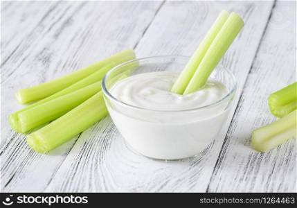 Leaf celery stalk dipped in Greek yogurt
