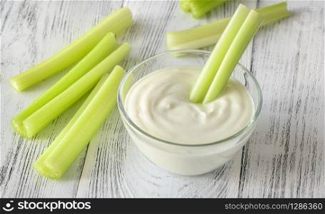 Leaf celery stalk dipped in Greek yogurt