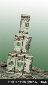 Leaning Tower of hundred dollar bills on green background
