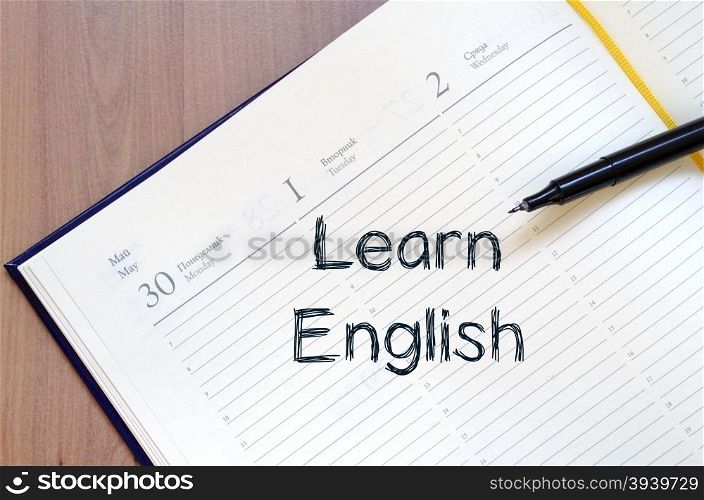 Learn english text concept write on notebook with pen