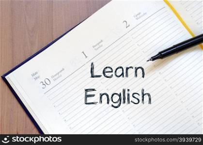 Learn english text concept write on notebook with pen