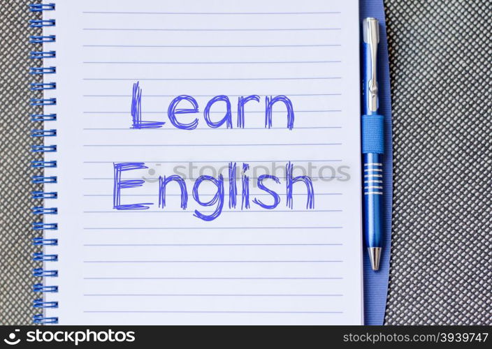 Learn english text concept write on notebook with pen