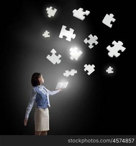 Learn logics thinking. Businesswoman with book in hands and puzzle elements in air