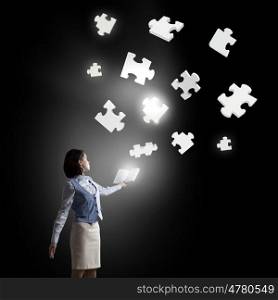 Learn logics thinking. Businesswoman with book in hands and puzzle elements in air