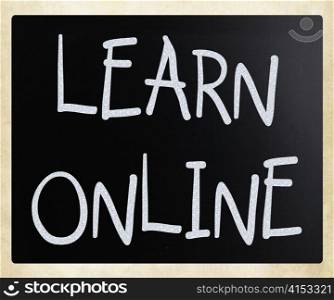 ""Learn online" handwritten with white chalk on a blackboard"