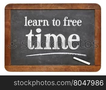 learn to free time - white chalk text on a vintage slate blackboard