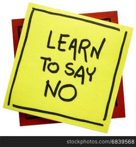 Learn to say no advice or reminder - handwriting on an isolated sticky note