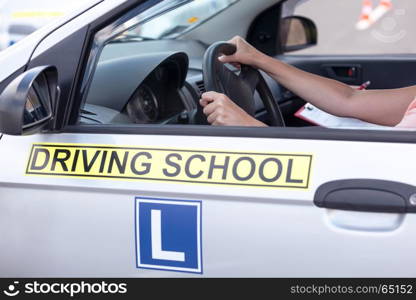 Learner driver student driving car with instructor