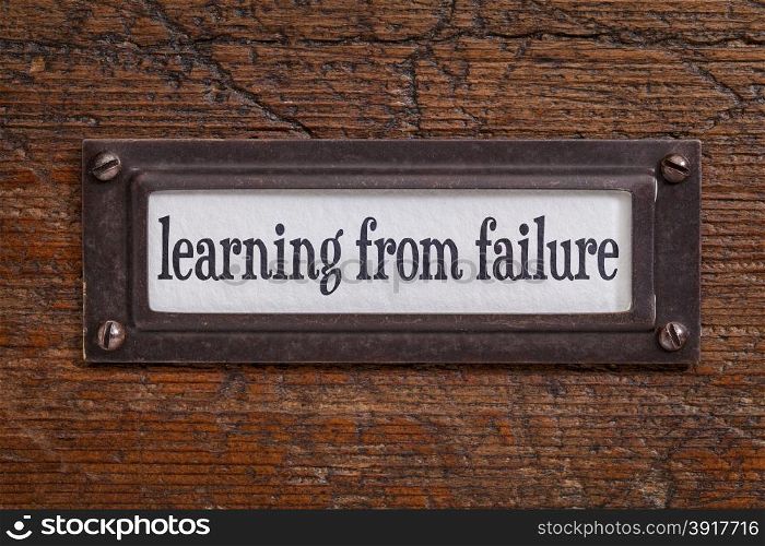 learning from failure - a label on a grunge wooden file cabinet