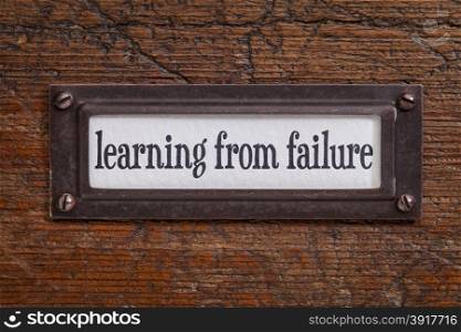 learning from failure - a label on a grunge wooden file cabinet