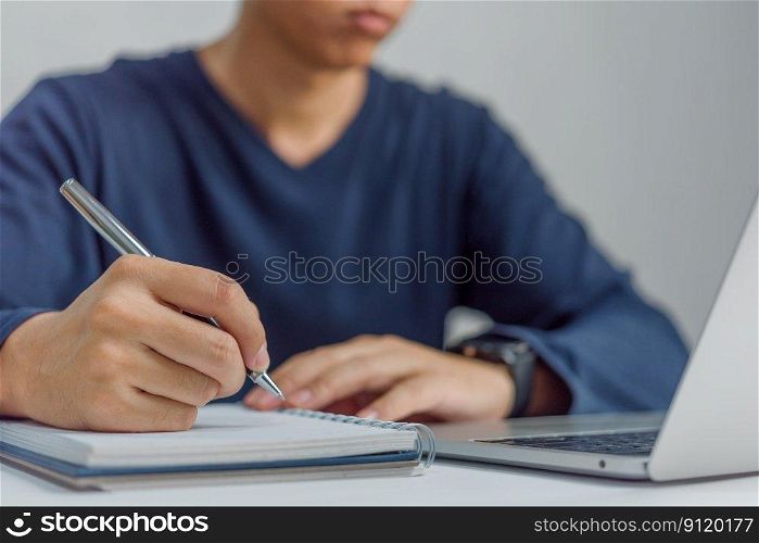 learning online class by using laptop computer and writing notebook at workplace, Education development or knowledge improvement concept.