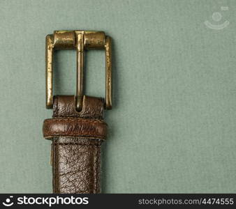 leather belt with a buckle on a green background