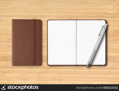 Leather closed and open lined notebooks with a pen. Mockup isolated on wooden background. Leather closed and open lined notebooks with a pen on wooden background