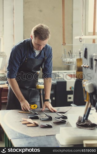 Leather craft workshop owner at his work place