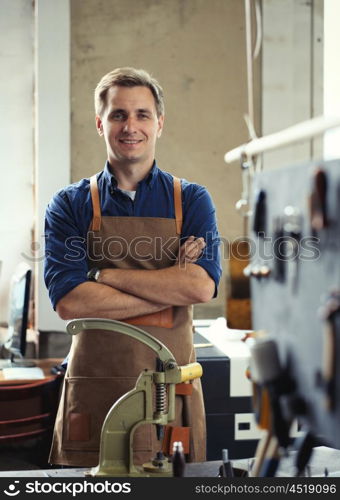 Leather craft workshop owner at his work place