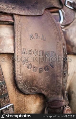 Leather Equestrian Saddle with All Around Cowboy Stamped in with Western Old Fashoned Letters Close up