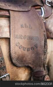 Leather Equestrian Saddle with All Around Cowboy Stamped in with Western Old Fashoned Letters Close up