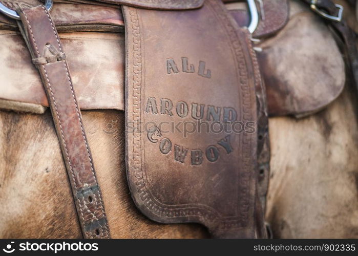 Leather Equestrian Saddle with All Around Cowboy Stamped in with Western Old Fashoned Letters Close up