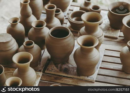 Leather hard handcraft clay pots waiting for dry and bisque fire in pottery process.