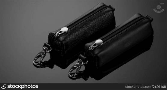 leather key case with zipper on black background. fashionable key case