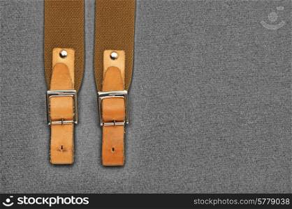 leather strap with a buckle on a gray background