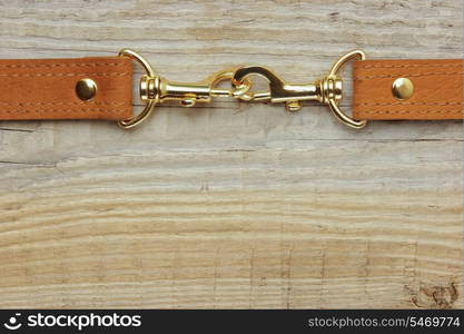 leather strap with carabiner on a wooden board