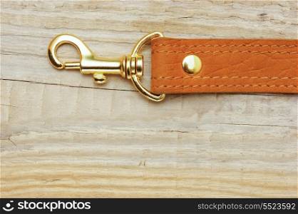 leather strap with carabiner on a wooden board
