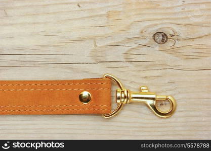 leather strap with carabiner on a wooden board