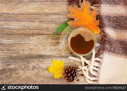 leaves and coffee on wooden top view autumn background. Fall leaves autumn background