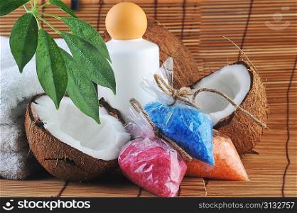 leaves, coconut, towel and salt for bath on straw napkin