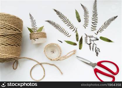 leaves scissor jute string wrapped candles white background. High resolution photo. leaves scissor jute string wrapped candles white background. High quality photo