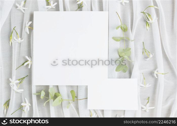 leaves twigs jasminum auriculatum flowers with wedding card scarf
