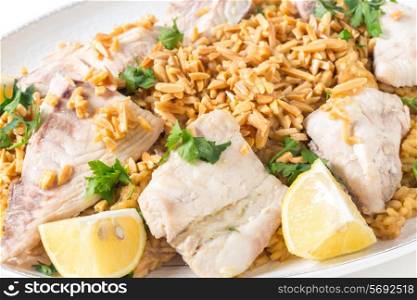 Lebaneses-style fried fish served with caramelised onion flavoured rice and roasted almond slivers.
