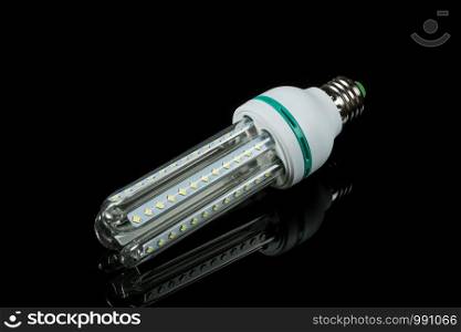 led energy saving lamps on black isolated background. on the glass