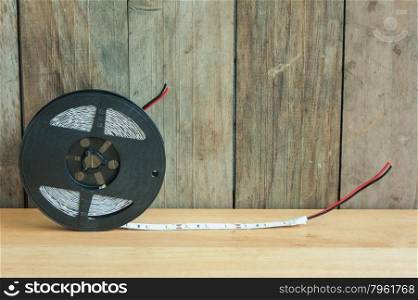 Led strip roll on wooden background