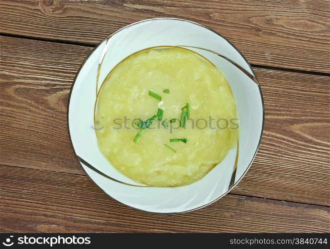 Leek soup a bowl on wooden background