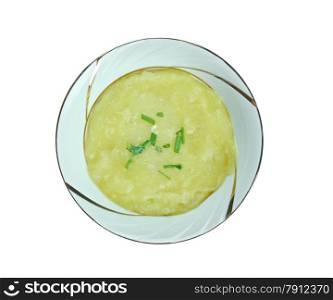 Leek soup a bowl on wooden background