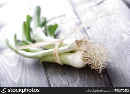 Leeks on wooden table - close-up