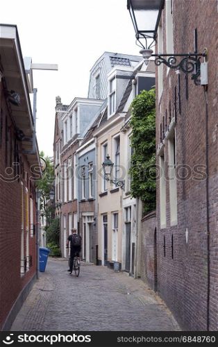 Leeuwarden, Netherlands, 11 june 2017: man on bicycle and old houses in the centre of old capital Leeuwarden of province of friesland in the netherlands