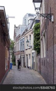 Leeuwarden, Netherlands, 11 june 2017: man on bicycle and old houses in the centre of old capital Leeuwarden of province of friesland in the netherlands