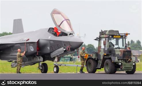 LEEUWARDEN, NETHERLANDS - JUNE 11 2016: F35 Joint Strike Fighter is towed to the hangar after a demonstration flight at the Dutch Air Force on juni 11 ,2016 in Leeuwarden.