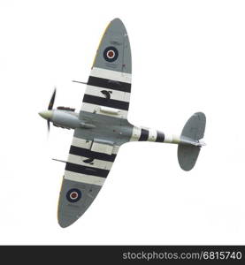 LEEUWARDEN, THE NETHERLANDS - JUNE 10, 2016: A vintage Spitfire fighter plane makes a low flypast for the public at the Royal Netherlands Air Force Days at Leeuwarden on June 10, 2016.