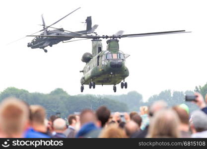 LEEUWARDEN, THE NETHERLANDS - JUNE 11, 2016: Dutch Chinook and Apache helicopter flying during the Royal Netherlands Air Force Days