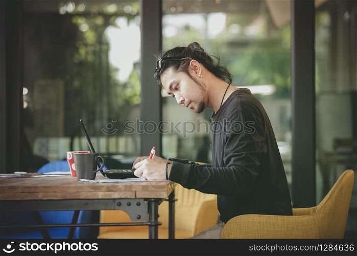 left handed freelance man write project in home working office