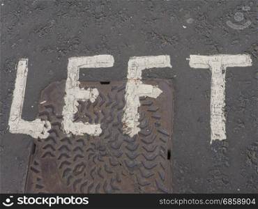 left sign on street. left sign written on street tarmac asphalt