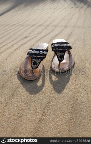 Left slippers on the sand