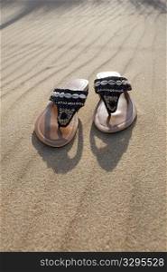 Left slippers on the sand