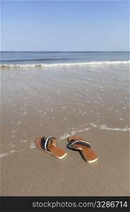 Left slippers on the seaside