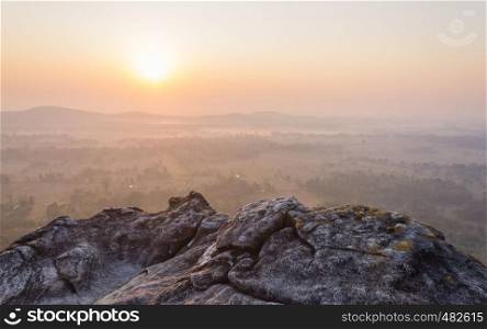 Left Sunrise at Pha Hua Rue Phayao Attractions Thailand Travel. Natural stone or rock mountain with sunrise sky and mist at Phayao northern Thailand travel