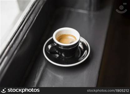 leftover coffee black cup window sill. Beautiful photo. leftover coffee black cup window sill